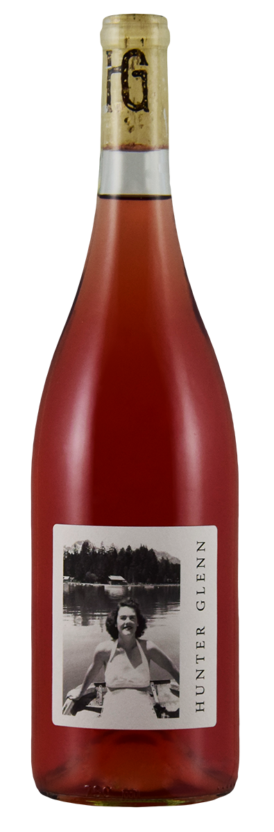 Bottle of 2025 HG Rosé wine with a label featuring a photograph of a person by a lake.